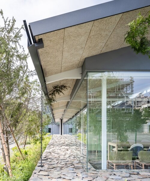 industrial metal trusses and local stones shape inorder studio's property showroom in taiwan
